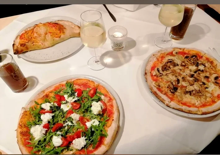 Verschiedene Pizzen auf dem Tisch bei Da Angelo